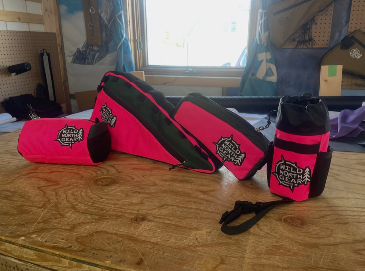 A matching set of hot pink bags on the workshop bench