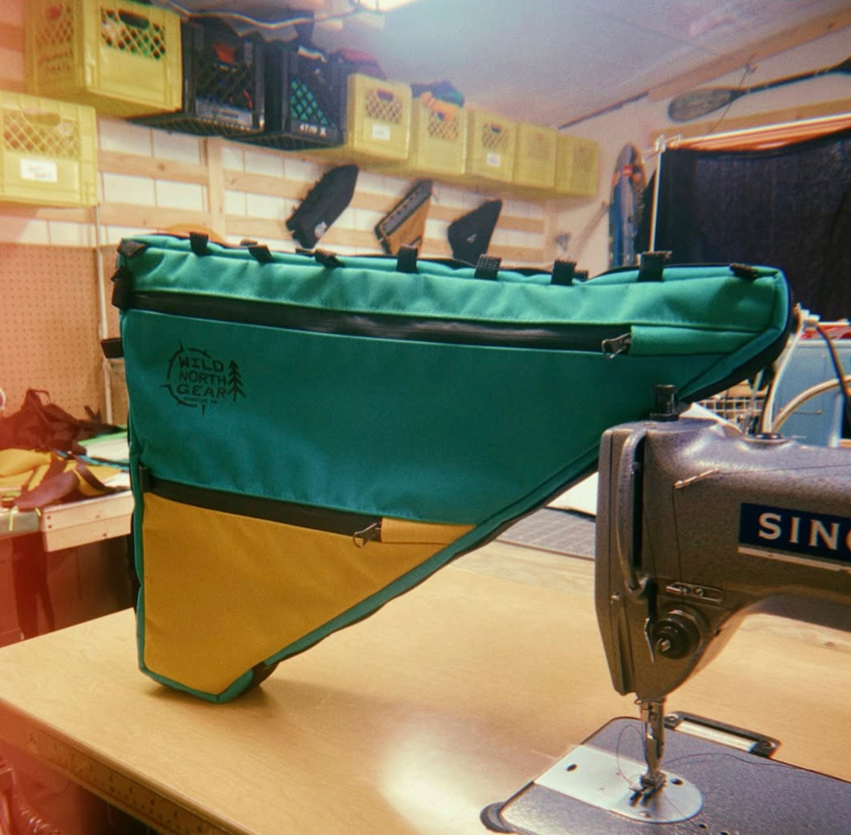 Emerald and mustard full frame bag propped on the Singer sewing machine